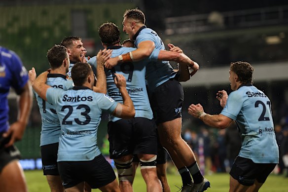 Joyous Waratahs players celebrate.