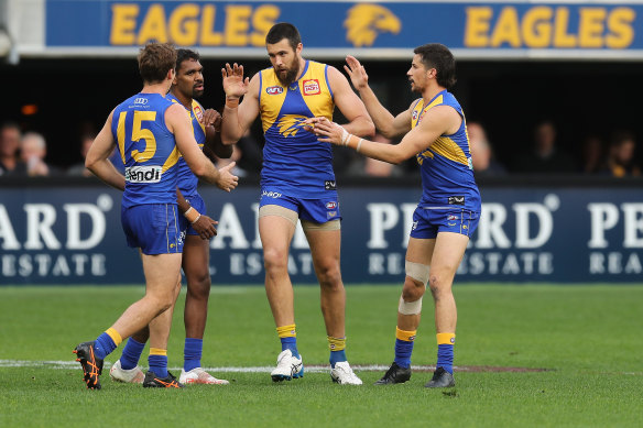 Josh Kennedy is congratulated by teammates after scoring.