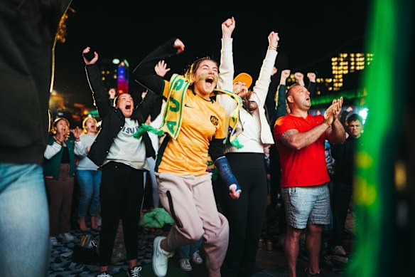 Soccer fans react to the intense penalty shootout, at Darling Harbour in Tumbalong Park.