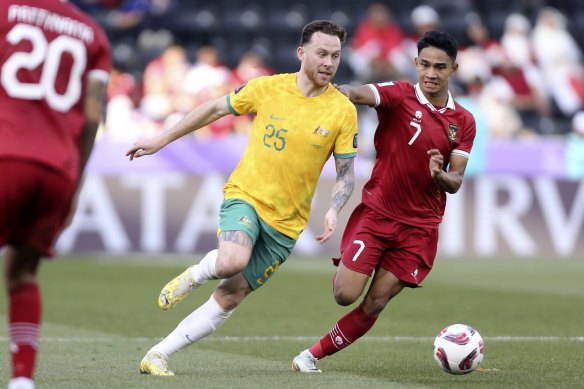 Socceroo Gethin Jones and Indonesia’s Marselino Ferdinan compete for the ball.