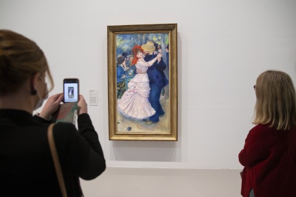 Viewers take in Renoir’s famous Dance at Bougival painting at the NGV. 
