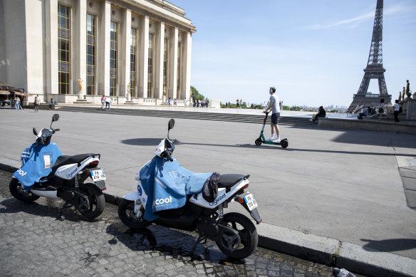 A pair of Pariscoot public hire electric scooters stand near the Eiffel Tower in Paris. Huge stimulus packages in Europe are likely to help countries recover from the coronavirus pandemic.