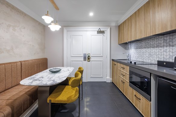 The one-bedroom accommodation has a dining nook with a four-seater marble-topped table.