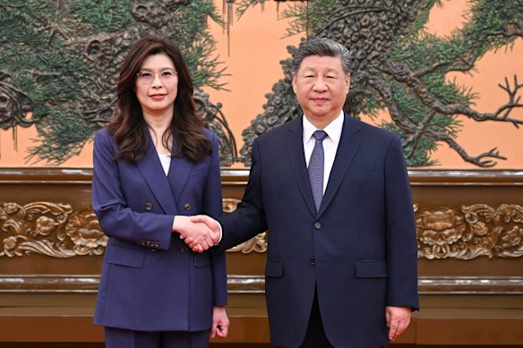 Chinese President Xi Jinping (right) shakes hands with Kuomintang (KMT) party leader Cheng Li-wun in Beijing on Friday.