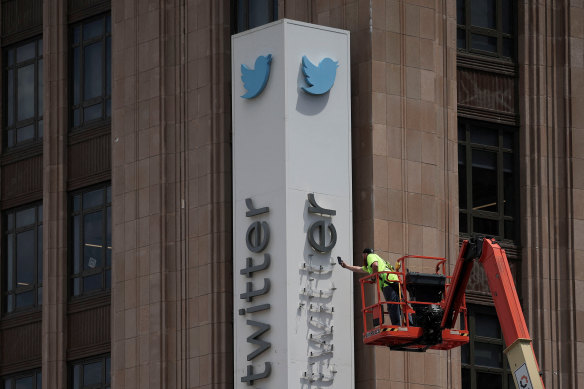 A worker dismantles Twitter’s sign at its corporate headquarters as Elon Musk renamed Twitter as X, in San Francisco on July 24.