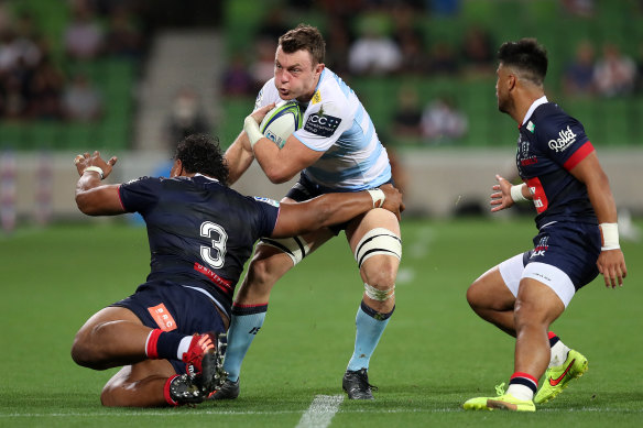 Jack Dempsey of the Waratahs gets muscled by the Rebels defence.