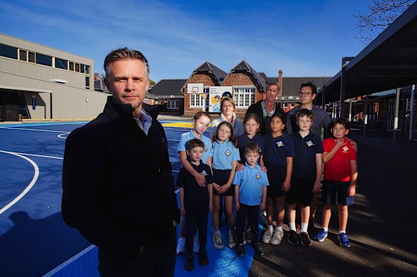 School council president Aaron Stead (left) with families at Brighton Primary School.