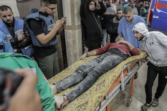 Palestinians injured in Israeli raids arrive at Nasser Medical Hospital, in Khan Younis, south Gaza.