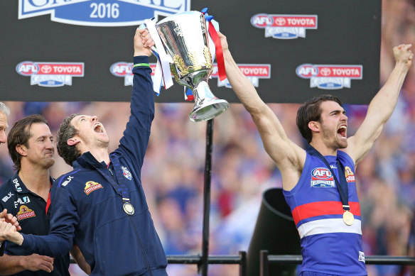 Western Bulldogs great Bob Murphy holds up the 2016 premiership cup with Easton Wood.