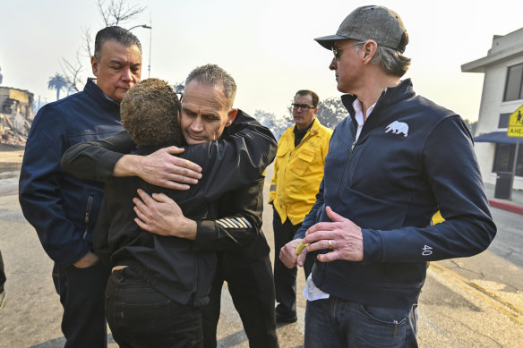 Los Angeles City fire captain Frank Lima, greets Los Angeles mayor Karen Bass, as she joins California Governor Gavin Newsom, right, and Senator Alex Padilla in the Palisades on Wednesday. 