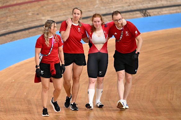 Rhian Edmunds of Team Wales is helped off the track.