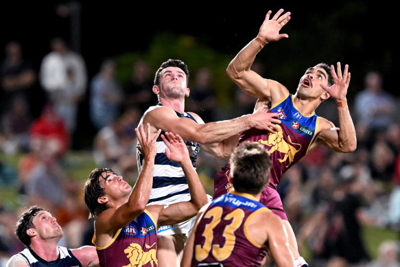 Charlie Cameron of the Lions and Jed Bews of the Cats challenge for the ball.