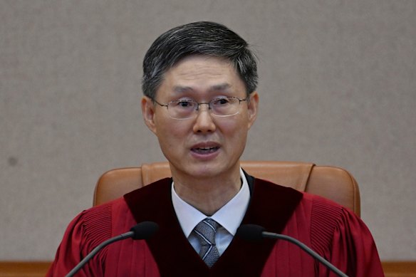 The court’s acting chief, Moon Hyung-bae, said the eight-member bench upheld Yoon’s impeachment because his martial law decree seriously violated the constitution and other laws. 