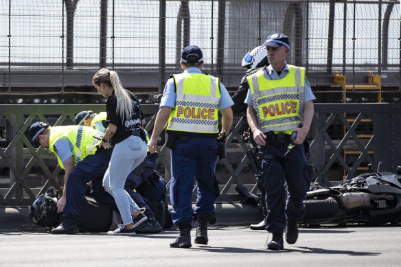 Police arrested a motorcyclist who attempted to ride through the crash site.