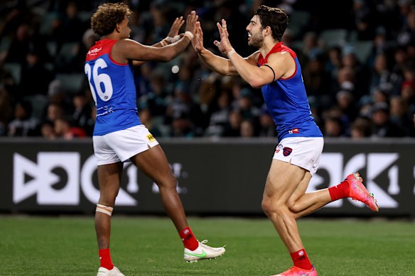 Kysaiah Pickett and Christian Petracca celebrate a goal.