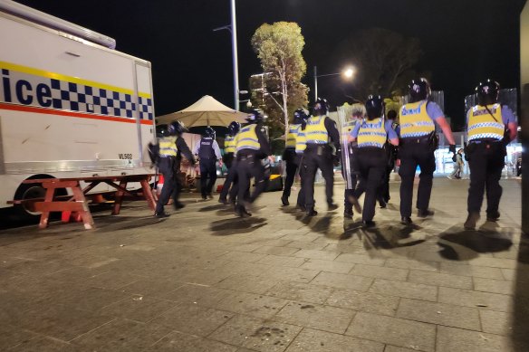 Police in riot gear confront mass fights in Perth’s CBD on Australia Day.