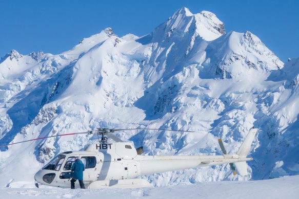 On the snow at the top of the glacier, the peaks of the NZ Southern Alps soaring above.