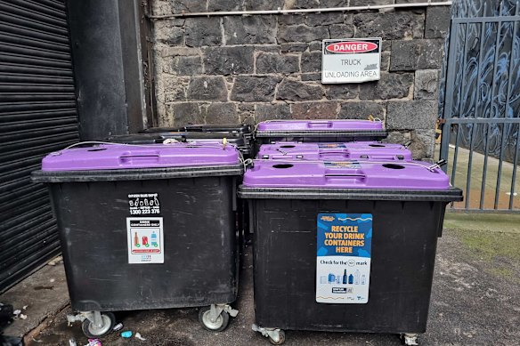 Padlocked skips for refundable bottles and cans in a Melbourne CBD laneway.