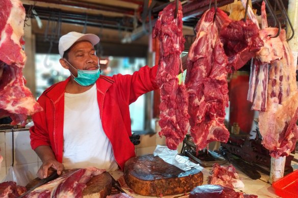 Indonesian beef seller Sukarma at the Rawamangun wet market in Jakarta.  