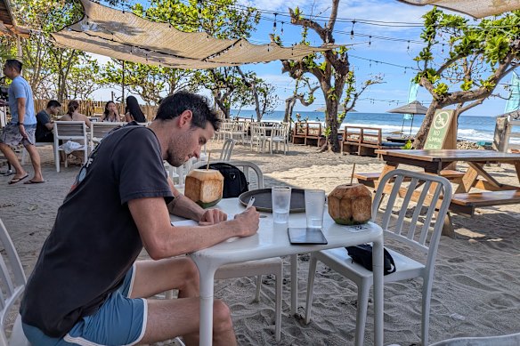 The author putting pen to paper on the road during his 20 years travelling the globe.