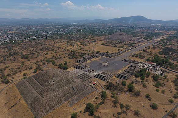 A Pirâmide da Lua, à esquerda, e a Pirâmide do Sol, atrás à direita, são vistas junto com estruturas menores que revestem a Avenida dos Mortos, em Teotihuacan, México.