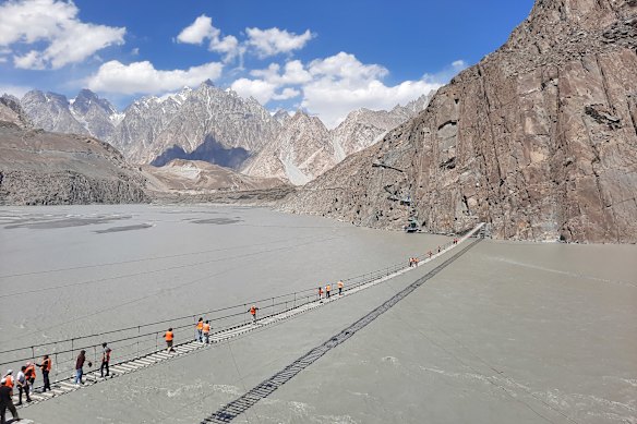 Hussaini Suspension Bridge, a precarious 193-metres-long rope bridge spanning the Hunza River that looks dangerous but is used daily by locals.