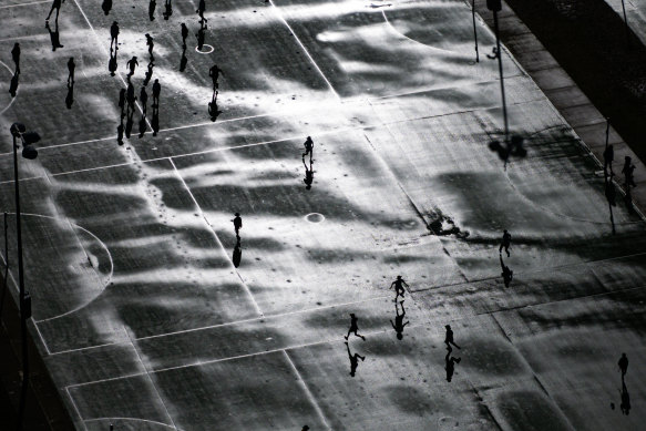 Drizzling and dribbling: Schoolchildren in Dee Why, Sydney, play on wet netball and basketball courts on Friday.