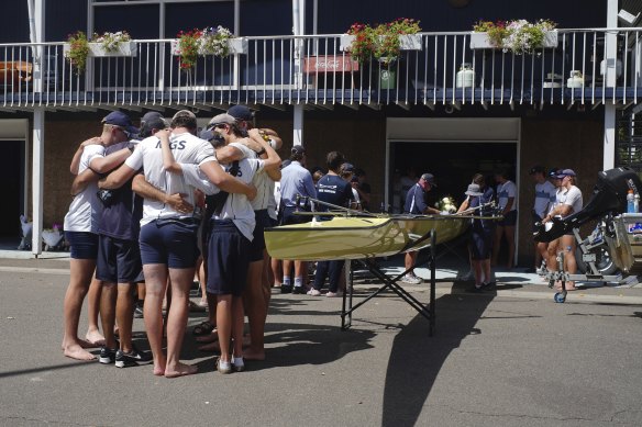Edward’s teammates embrace before taking to the water on Saturday.