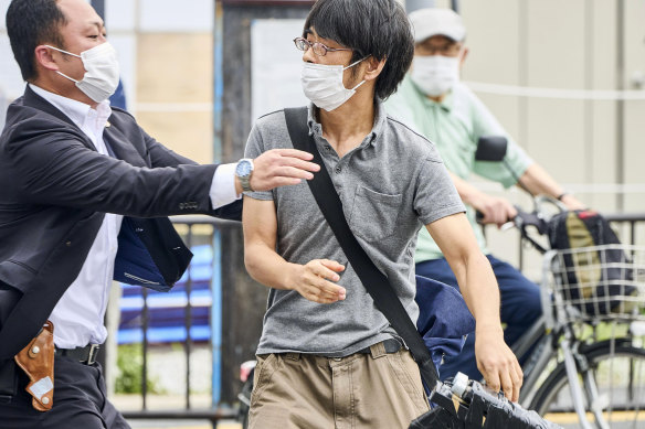 Tetsuya Yamagami, holding a DIY weapon, is detained after former Japanese prime minister Shinzo Abe was assassinated.