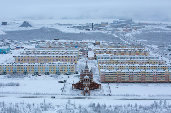 Residential apartment blocks for workers stand beyond a Russian orthodox church near the Udachny diamond mine operated by OAO Alrosa in Udachny, Russia.