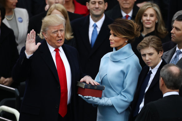 Donald Trump takes the oath of office as his wife Melania Trump, looks on during the presidential inauguration in January 2017.