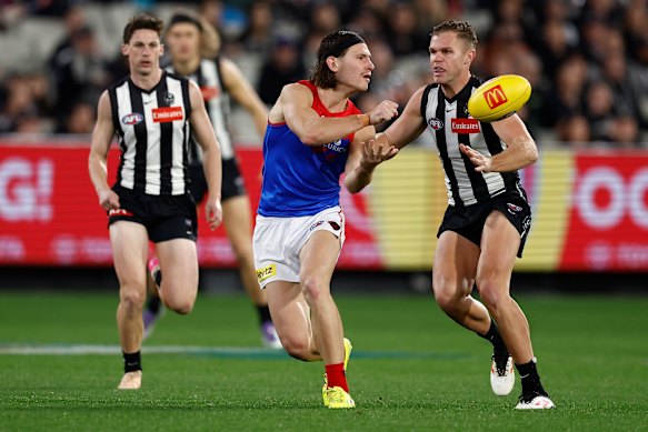 Jai Culley of the Demons handpasses the ball.