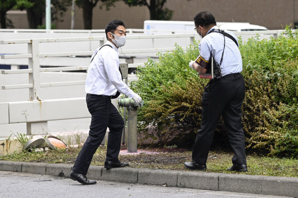 Police at the scene where a man set himself on fire near the prime minister’s office in Tokyo.  