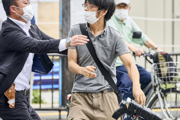 Tetsuya Yamagami, holding a DIY weapon, is detained after former prime minister Shinzo Abe was assassinated.