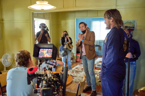 Trent Dalton, centre, on the set of Boy Swallows Universe with Travis Fimmel, right.