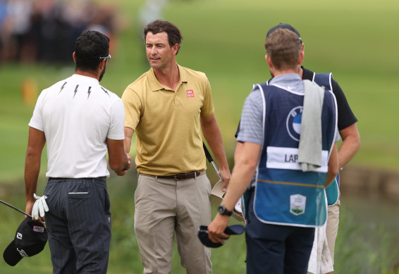 Adam Scott and Francesco Laporta shake hands on the 18th green after completing their rounds at Wentworth.