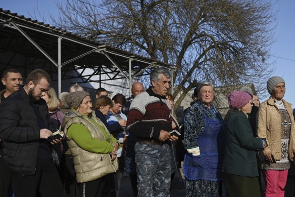 Residents of Lymany village queue for food packages at a World Kitchen humanitarian aid distribution point in Lymany, Mykolaiv Oblast.