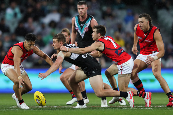 Port Adelaide's Ollie Wines takes on  Dylan Shiel and Zach Merrett during the win over the Bombers on Saturday.