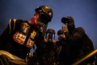 Demonstrators wear gas masks during a strike rally at Tamar Park.