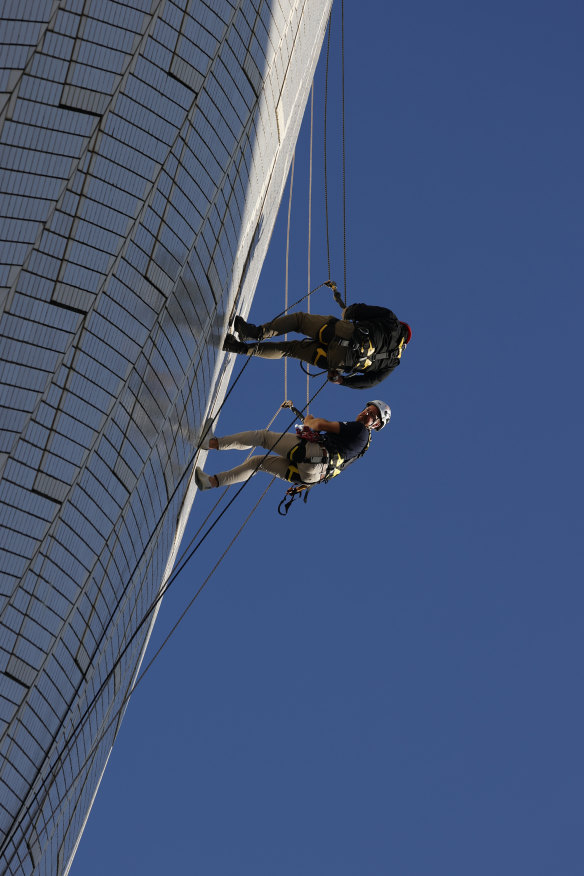 Building operations manager Dean Jakubowski and height access specialist Dean Gillies abseil down the eastern side of the A2 shell.