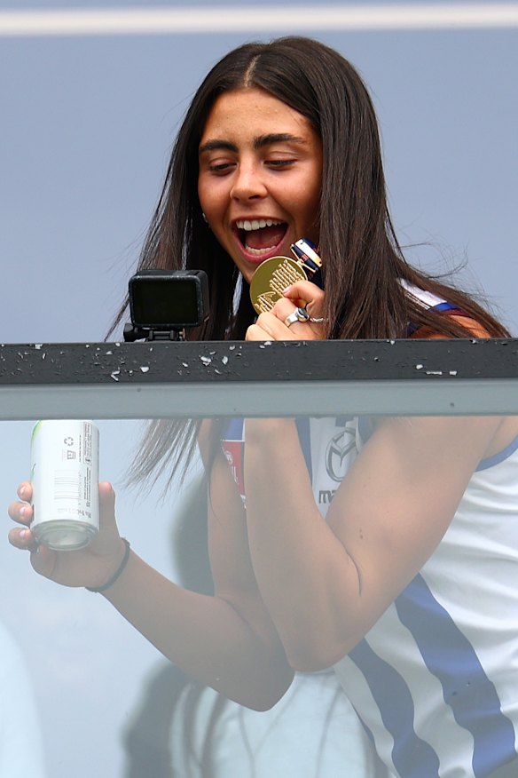 Taylah Gatt brandishing her premiership medal.