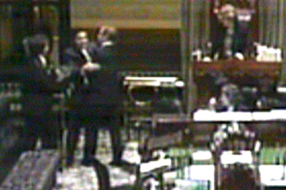 NSW National Party MP Andrew Fraser (third from left) confronts Roads Miniter Joe Tripodi (second from left) during a sitting of NSW Parliament. 