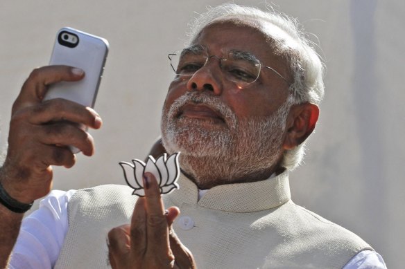 Modi takes a selfie with his party's lotus symbol before his election win in 2014. 