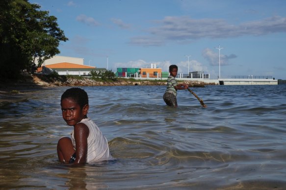 Children play near a new wharf in Luganville, Vanuatu. 