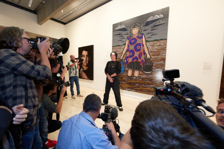 Blak Douglas with his portrait of Karla Dickens, which won the Archibald Prize 2022, at the announcement. Artwork © Blak Douglas