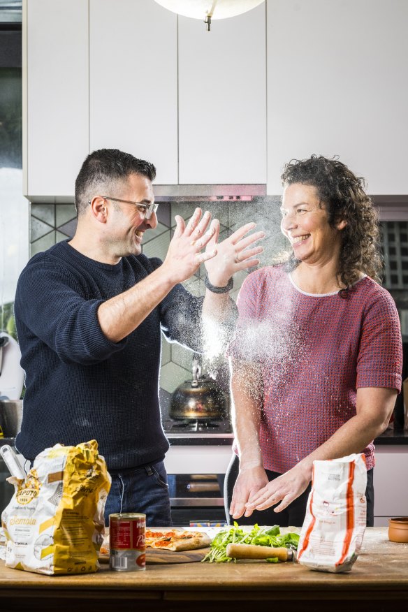 Pizzaiolo Mariano De Giacomi shows Dani Valent how to make pizza dough.