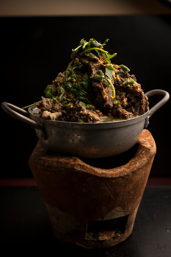 Leng zaap, pork spine soup, balances on a claypot.