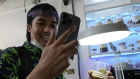 A customer talks on his mobile phone as he buys marijuana at the Highland Café in Bangkok, Thailand.