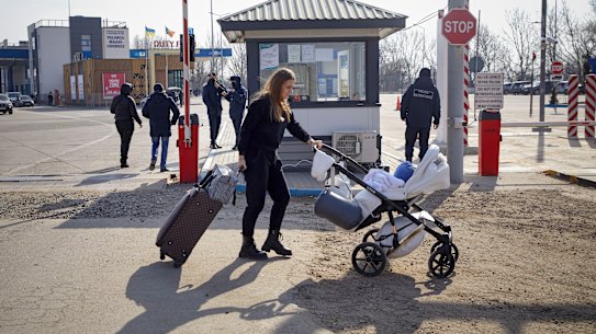 A refugee who fled the conflict in Ukraine crosses the border at Palanca, Moldova on Saturday.