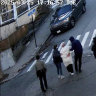 In this image taken from security footage, Rumeysa Ozturk, a 30-year-old doctoral student at Tufts University, is detained by Department of Homeland Security agents on a street in Sommerville, Massachusetts.